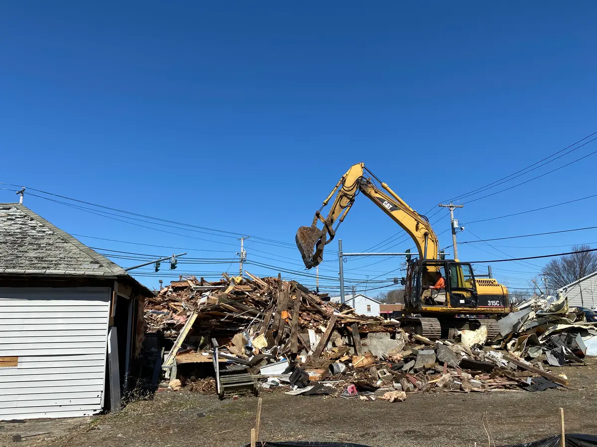 PRC Demolition excavator processing the debris pile on a Milford, CT teardown